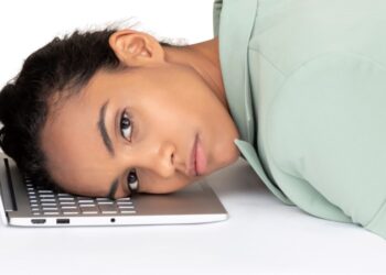 a-woman-resting-her-head-on-a-laptop-computer-2022-07-07-01-14-38-utc